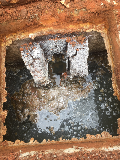 Corroded-off-outlet-tee-on-septic-tank
